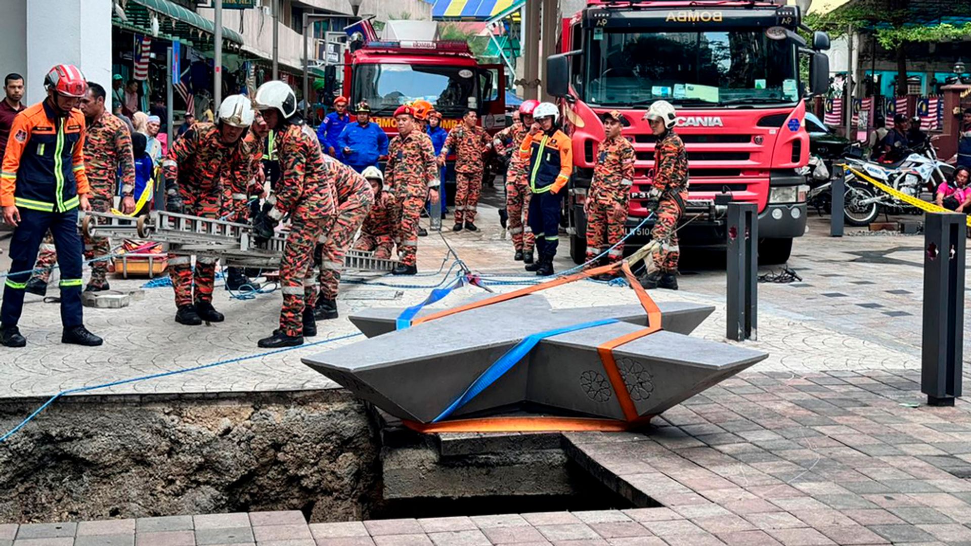 Woman missing after plunging into 8m-deep pavement sinkhole in Malaysia