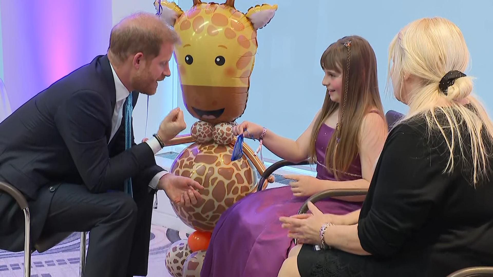 Girl, 10, who saves pocket money to buy toys for hospitals gives Prince Harry gifts at London event